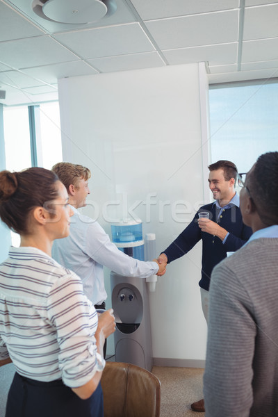 Mutlu iş arkadaşları el sıkışmak ofis Stok fotoğraf © wavebreak_media