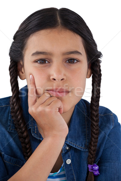 Girl with hand on chin against white background Stock photo © wavebreak_media
