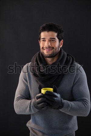 Smiling man holing a mug of coffee Stock photo © wavebreak_media