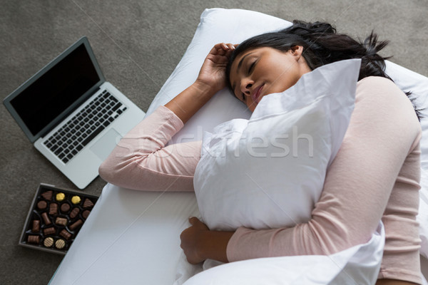 Woman sleeping on bed over floor Stock photo © wavebreak_media