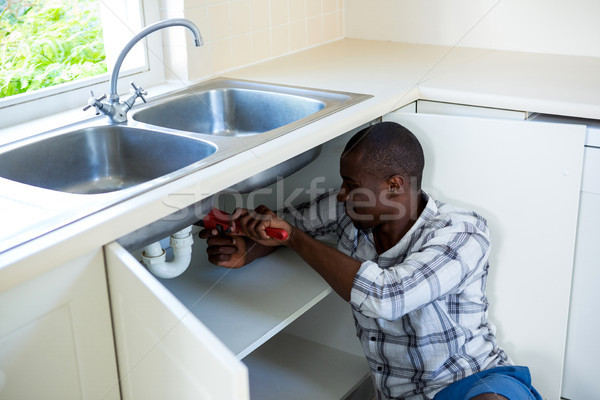 Man repairing a kitchen sink Stock photo © wavebreak_media