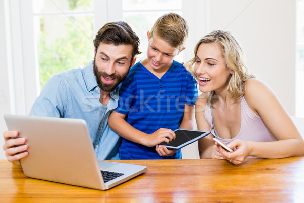 Parents and son using a laptop, tablet and phone Stock photo © wavebreak_media