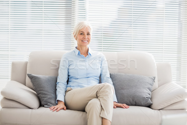Portrait of smiling senior woman on sofa Stock photo © wavebreak_media