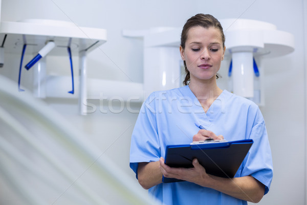 Dental assistant holding clipboard Stock photo © wavebreak_media