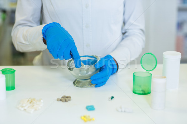 Pharmacist grinding medicine in mortal and pestle Stock photo © wavebreak_media