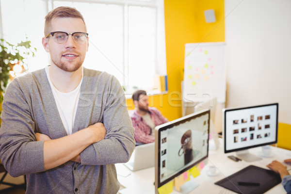 Stock photo: Portrait of confident editor with arms crossed at creative office