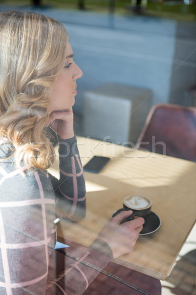 Woman having coffee in cafeteria Stock photo © wavebreak_media