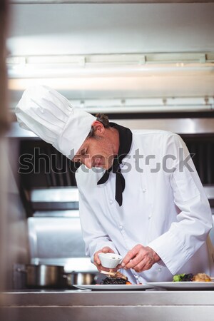Female butcher arranging hamburger patty on tray Stock photo © wavebreak_media