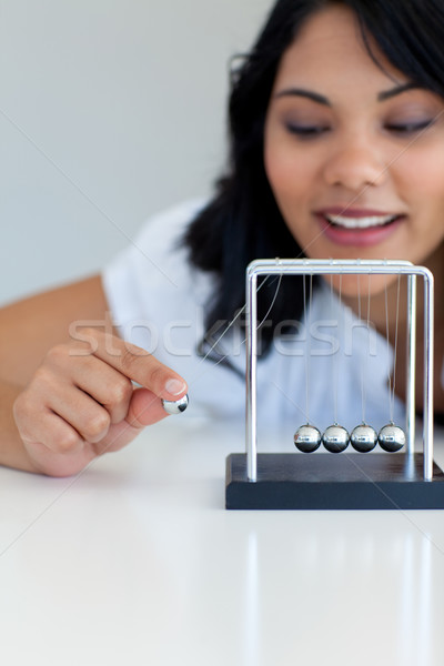 Businesswoman moving kinetic balls Stock photo © wavebreak_media