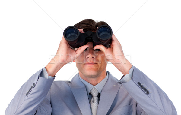 Serious businessman looking through binoculars Stock photo © wavebreak_media