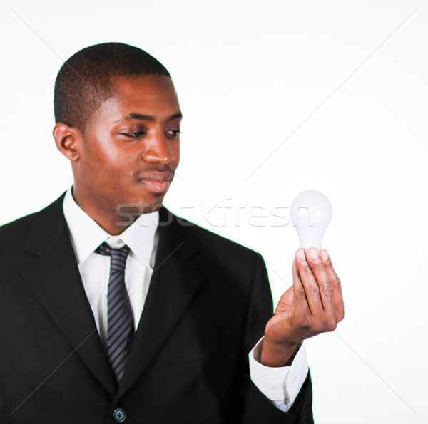 Confident businessman looking at a light bulb  Stock photo © wavebreak_media