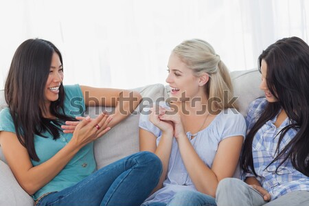 Goodlooking young woman separated from the others in a living room Stock photo © wavebreak_media