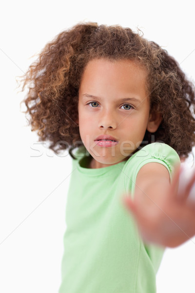 Portrait of a girl saying stop with her hand against white background Stock photo © wavebreak_media