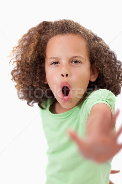 Portrait of an unhappy girl saying stop with her hand against a white background Stock photo © wavebreak_media