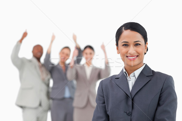 Stock photo: Smiling tradeswoman with cheering team behind her against a white background