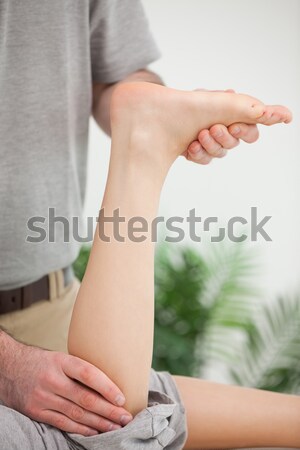 Woman lying forward while being stretched in a room Stock photo © wavebreak_media