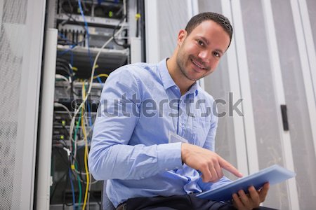 Man using tablet pc beside servers in data center Stock photo © wavebreak_media