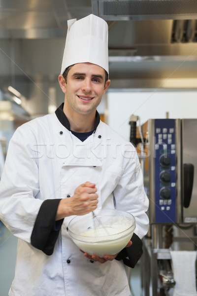 Cheerful man mixing batter in the kitchen Stock photo © wavebreak_media