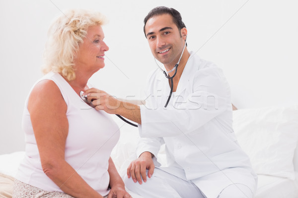 Smiling doctor examining an old woman Stock photo © wavebreak_media