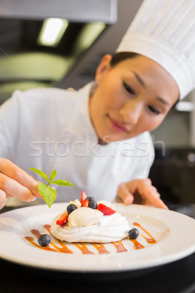 Concentrated female chef garnishing food Stock photo © wavebreak_media