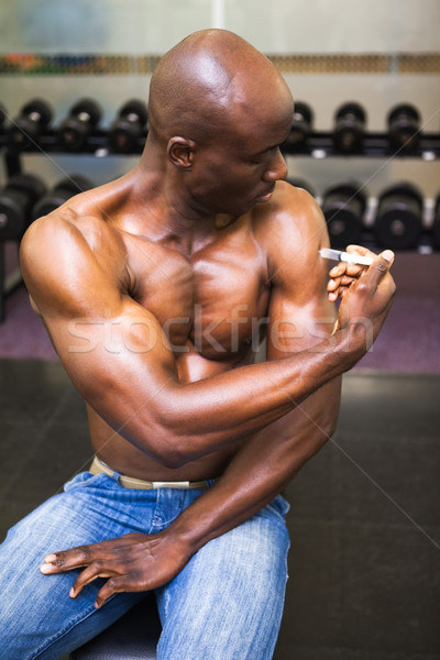 Muscular man injecting steroids Stock photo © wavebreak_media