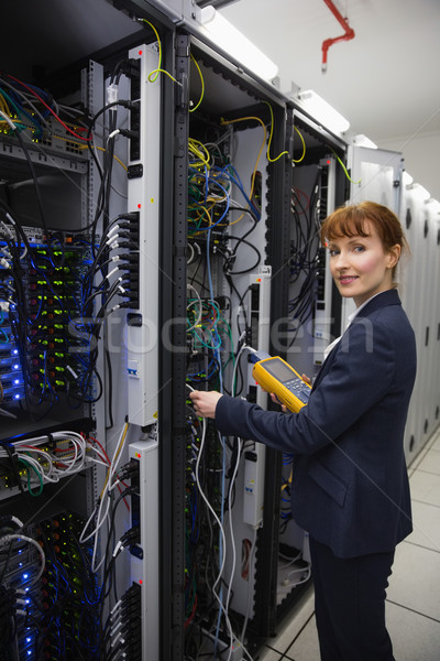 Happy technician using digital cable analyzer on server  Stock photo © wavebreak_media