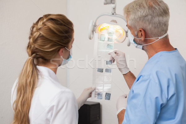 Dentist and assistant studying x-rays Stock photo © wavebreak_media