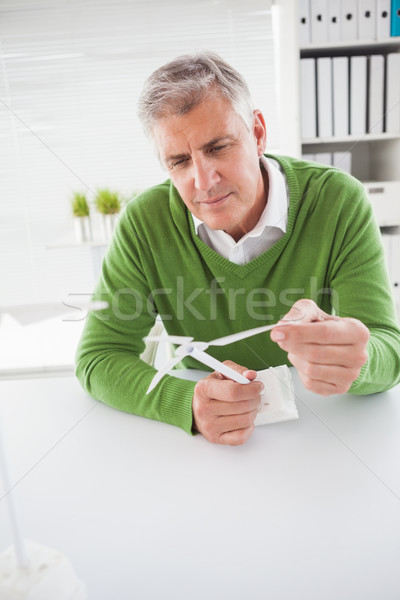 Casual businessman looking at model wind turbines  Stock photo © wavebreak_media