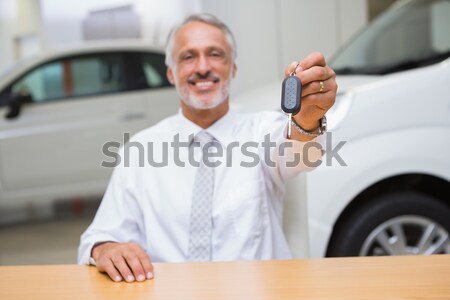 Smiling salesman giving a customer car keys Stock photo © wavebreak_media