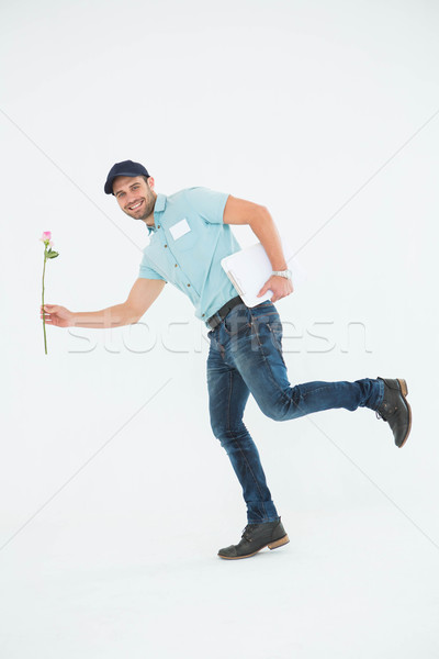 Flower delivery man running on white background Stock photo © wavebreak_media