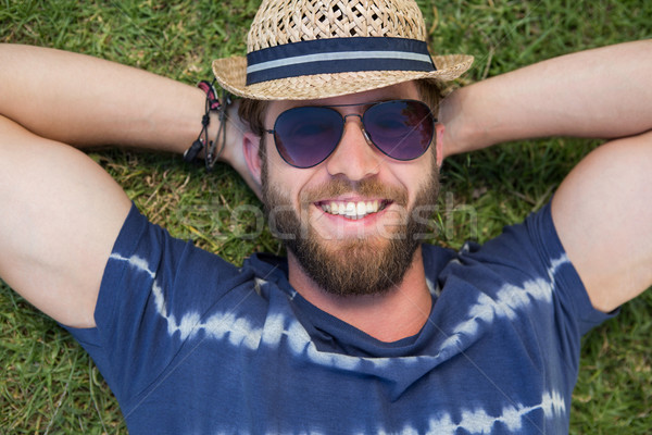 Handsome hipster lying on grass Stock photo © wavebreak_media