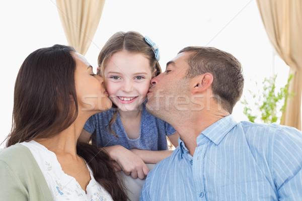 Happy girl being kissed by parents Stock photo © wavebreak_media
