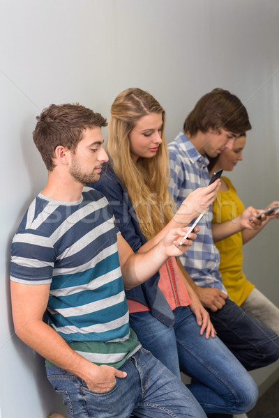 College students using cellphones Stock photo © wavebreak_media