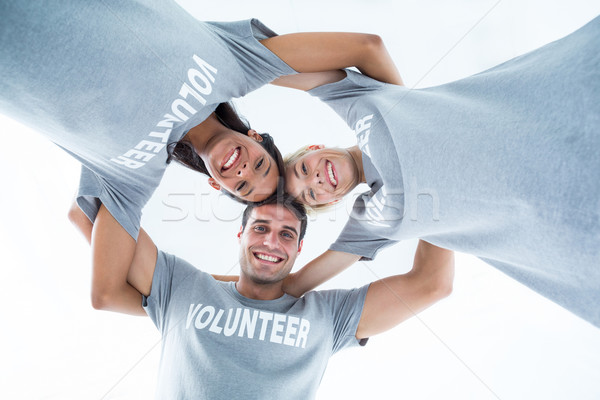 Stock photo: Happy volunteers forming huddle