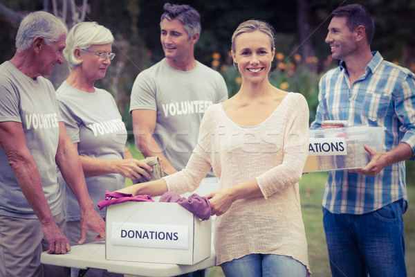 Happy volunteer family separating donations stuffs Stock photo © wavebreak_media