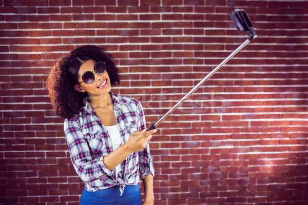 Attractive hipster taking selfies with selfiestick Stock photo © wavebreak_media