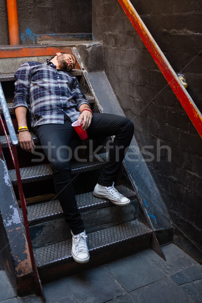 Drunk man lying on staircase Stock photo © wavebreak_media