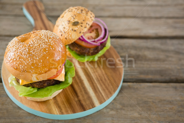 High angle view of burger on wooden cutting board Stock photo © wavebreak_media