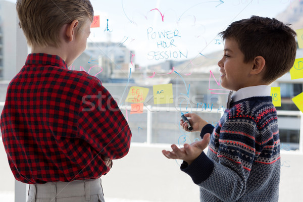 Stock photo: Kids as business executives discussing over whiteboard