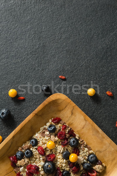 Plate of breakfast cereal with fruits on black background Stock photo © wavebreak_media