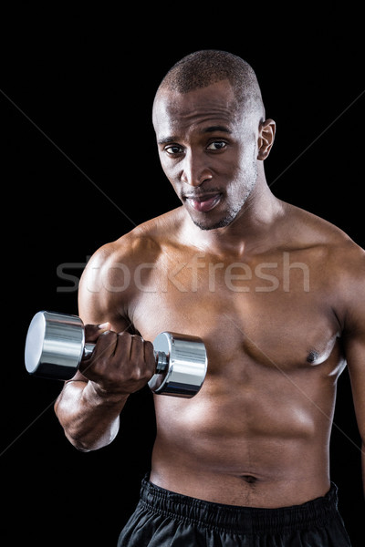 Portrait of athlete exercising with dumbbell Stock photo © wavebreak_media