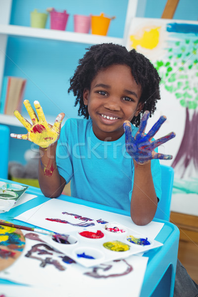 Happy kid enjoying painting with his hands Stock photo © wavebreak_media