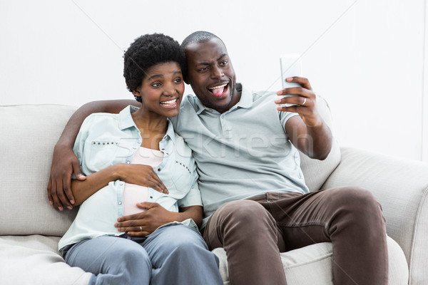 Pregnant couple taking a selfie on mobile phone Stock photo © wavebreak_media
