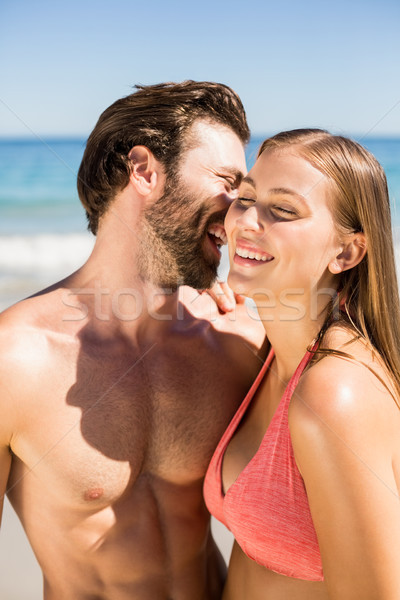 Young man whispering in his partner ear Stock photo © wavebreak_media