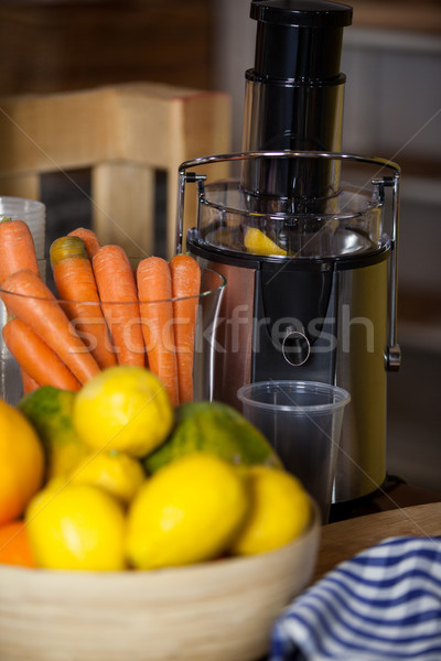Juicer with carrot and lemon in a bowl Stock photo © wavebreak_media