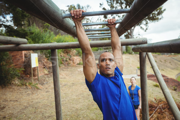 Fit man climbing monkey bars Stock photo © wavebreak_media