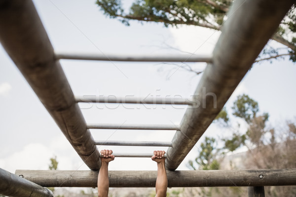 Fit man climbing monkey bars during obstacle course Stock photo © wavebreak_media