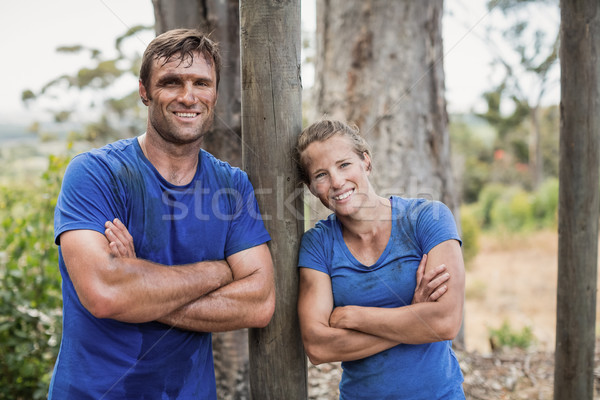 Smiling man and woman standing with arms crossed during obstacle course Stock photo © wavebreak_media