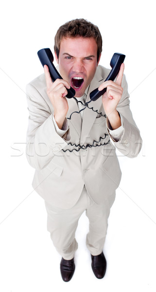 Stressed businessman yelling tangled up in phone wires  Stock photo © wavebreak_media