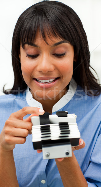 Stock photo: Ethnic businesswoman consulting a business card holder